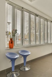 seating-area-with-two-blue-tables-window -re